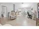 Bright open-concept living area featuring light tile floors, access to kitchen and dining and neutral wall colors at 2924 Se 142Nd Pl, Summerfield, FL 34491