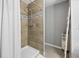 Shower stall showcases tiled walls, modern fixtures, and a shower curtain at 2924 Se 142Nd Pl, Summerfield, FL 34491