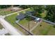 Aerial view of the property showing a spacious, fenced backyard, storage shed, and proximity to nearby homes at 3094 Se 144Th Pl, Summerfield, FL 34491