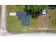 Aerial view of house with dark roof, detached shed, concrete driveway, and spacious lot at 3094 Se 144Th Pl, Summerfield, FL 34491