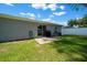 Backyard with a concrete patio and small lawn, offering an inviting outdoor space at 3094 Se 144Th Pl, Summerfield, FL 34491