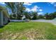 Spacious backyard featuring a white fence, storage shed, bench, and mature trees creating a private outdoor space at 3094 Se 144Th Pl, Summerfield, FL 34491