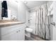 Bright bathroom featuring a shower-tub combo and a single sink vanity with gray countertops at 3094 Se 144Th Pl, Summerfield, FL 34491