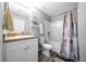 Bright bathroom with a shower-tub combo, floating shelves and a single sink vanity with gray countertops at 3094 Se 144Th Pl, Summerfield, FL 34491