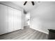 Spacious bedroom with closet and gray wood floors, providing ample space and storage solutions at 3094 Se 144Th Pl, Summerfield, FL 34491
