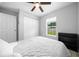 Well-lit bedroom featuring a ceiling fan, a built-in shelving unit, and a large window at 3094 Se 144Th Pl, Summerfield, FL 34491