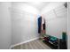 Corner walk-in closet featuring wire shelving and modern gray-wood flooring at 3094 Se 144Th Pl, Summerfield, FL 34491
