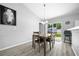 Cozy dining area with a four-seat table that opens to a fenced backyard and detached storage shed at 3094 Se 144Th Pl, Summerfield, FL 34491