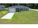 Charming single-story home with a well-manicured lawn and attached two-car garage, perfect for suburban living at 3094 Se 144Th Pl, Summerfield, FL 34491
