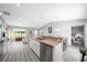 Spacious modern kitchen flowing into the living areas features stainless steel appliances, white cabinets and lots of light at 3094 Se 144Th Pl, Summerfield, FL 34491