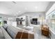 Bright, open-concept living space featuring modern furniture, stylish decor, and hardwood flooring throughout at 3094 Se 144Th Pl, Summerfield, FL 34491