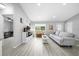 Bright, open-concept living space featuring modern furniture, stylish decor, and hardwood flooring throughout at 3094 Se 144Th Pl, Summerfield, FL 34491