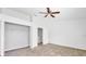 Spacious bedroom with neutral carpet, a ceiling fan, closet, and a bright atmosphere at 329 Marion Oaks Blvd # A3, Ocala, FL 34473