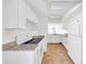 Well-lit kitchen featuring white cabinets, granite countertops, and modern appliances at 329 Marion Oaks Blvd # A3, Ocala, FL 34473