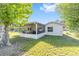 Backyard view featuring a screened porch and green lawn at 3428 Ne 17Th Ter, Ocala, FL 34479