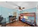 Bedroom includes bunk beds, desk, ceiling fan, and hardwood-style floors at 3428 Ne 17Th Ter, Ocala, FL 34479