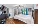 Bedroom featuring laminate floors, closet, window, and plenty of natural light at 3428 Ne 17Th Ter, Ocala, FL 34479