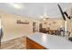 Open kitchen and dining area features tile floors, ceiling fan, and natural light at 3428 Ne 17Th Ter, Ocala, FL 34479