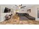 Open concept living room featuring tile floors, a sleek leather sofa, and ample natural light at 3428 Ne 17Th Ter, Ocala, FL 34479