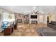 Inviting living room with a brick fireplace, light-filled window, and sleek tile flooring at 3428 Ne 17Th Ter, Ocala, FL 34479