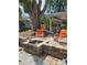 Backyard brick patio with a fire pit, seating, a large tree, and access to the home at 3709 Ne 4Th St, Ocala, FL 34470