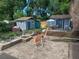 Spacious backyard featuring a brick patio with fire pit and cozy blue storage sheds at 3709 Ne 4Th St, Ocala, FL 34470