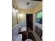 Modest bathroom with linoleum floor, gray towels, and retro light fixture at 3709 Ne 4Th St, Ocala, FL 34470