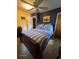Bright bedroom features yellow walls, blue accent wall, ceiling fan, and wood furniture at 3709 Ne 4Th St, Ocala, FL 34470