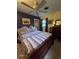 Comfortable bedroom with ceiling fan, blue accent wall, and patterned bedding at 3709 Ne 4Th St, Ocala, FL 34470