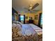 Cozy bedroom with patterned bedding, ceiling fan, and warm yellow walls at 3709 Ne 4Th St, Ocala, FL 34470
