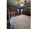 Spacious bedroom with wooden bed, blue-gray walls, and dresser with mirror at 3709 Ne 4Th St, Ocala, FL 34470