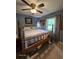Charming bedroom with wooden bed frame, neutral bedding, and blue painted walls at 3709 Ne 4Th St, Ocala, FL 34470