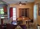 Bright dining area with a classic wood table, chairs, and a stylish china cabinet, adjacent to kitchen at 3709 Ne 4Th St, Ocala, FL 34470