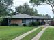 Charming single-story home with a well-manicured lawn and a brick accent wall, plus a long, private driveway at 3709 Ne 4Th St, Ocala, FL 34470