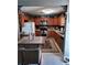 Efficient kitchen with wooden cabinets, black countertops, stainless steel appliances, and charming decor at 3709 Ne 4Th St, Ocala, FL 34470