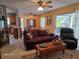 Inviting living room featuring a comfortable sofa, ceiling fan, and natural light streaming through a large window at 3709 Ne 4Th St, Ocala, FL 34470