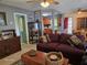 Inviting living room featuring a comfortable sofa and seamless transition to the kitchen and dining areas at 3709 Ne 4Th St, Ocala, FL 34470