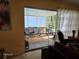 View of a screened porch with multiple chairs and a table set for entertaining, accessible from the living room at 3709 Ne 4Th St, Ocala, FL 34470