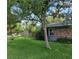 Landscaped side yard featuring green grass, pink flowers, and lush greenery, offering a serene outdoor space at 3709 Ne 4Th St, Ocala, FL 34470