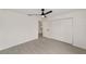 A bright bedroom with wood-look flooring, closet and doorway to an adjacent room at 391 Nw Crocus Ln, Dunnellon, FL 34431