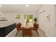 Dining room featuring modern table, seating for six, sliding door to the outdoors, and closet at 391 Nw Crocus Ln, Dunnellon, FL 34431