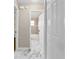 Hallway view of a bathroom, featuring marble tile flooring and a bathtub/shower at 4250 Nw 26Th Ter, Ocala, FL 34475