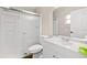 Well-lit bathroom featuring a shower with sliding door, vanity with sink, and toilet at 4250 Nw 26Th Ter, Ocala, FL 34475