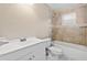 Bathroom with modern sink and vanity, plus a bathtub with tiled surround and updated shower head at 4250 Nw 26Th Ter, Ocala, FL 34475
