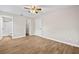Bright bedroom with wood-look flooring, ceiling fan and access to the bathroom and walk-in closet at 4250 Nw 26Th Ter, Ocala, FL 34475