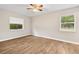 Bedroom featuring two windows for natural light, complemented by neutral walls and wood flooring at 4250 Nw 26Th Ter, Ocala, FL 34475