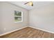 Neutral bedroom with hardwood flooring, bright window, and ample wall space at 4250 Nw 26Th Ter, Ocala, FL 34475