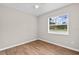 Comfortable bedroom with wood floors, a ceiling fan, and a window for natural light at 4250 Nw 26Th Ter, Ocala, FL 34475