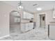 Open kitchen with white cabinetry, granite countertops, stainless steel appliances, and modern lighting at 4250 Nw 26Th Ter, Ocala, FL 34475