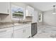 Modern kitchen featuring white cabinets, stainless steel appliances, and granite countertops at 4250 Nw 26Th Ter, Ocala, FL 34475